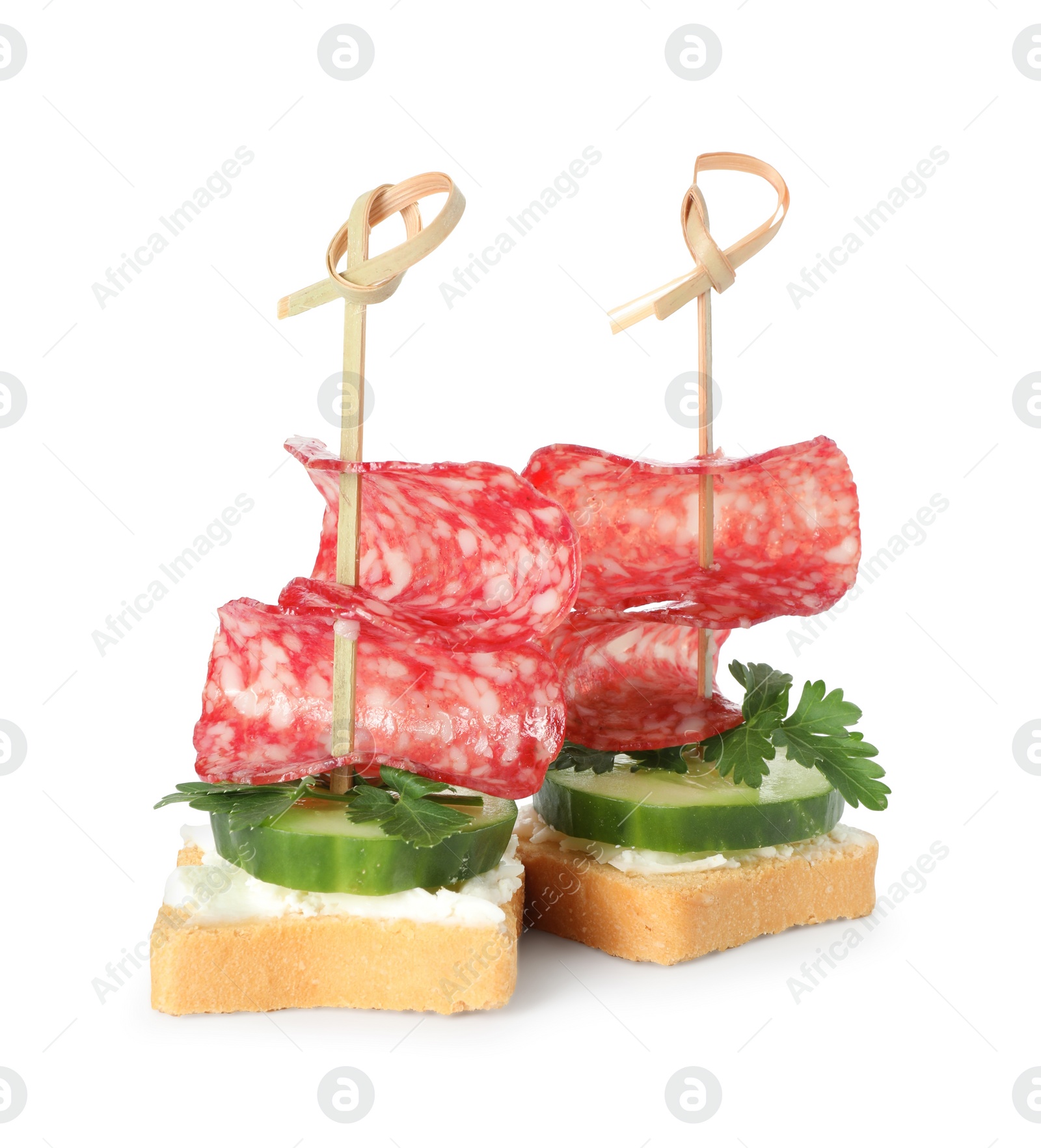 Photo of Tasty canapes with salami, cucumber and cream cheese isolated on white