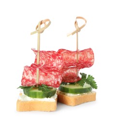 Photo of Tasty canapes with salami, cucumber and cream cheese isolated on white