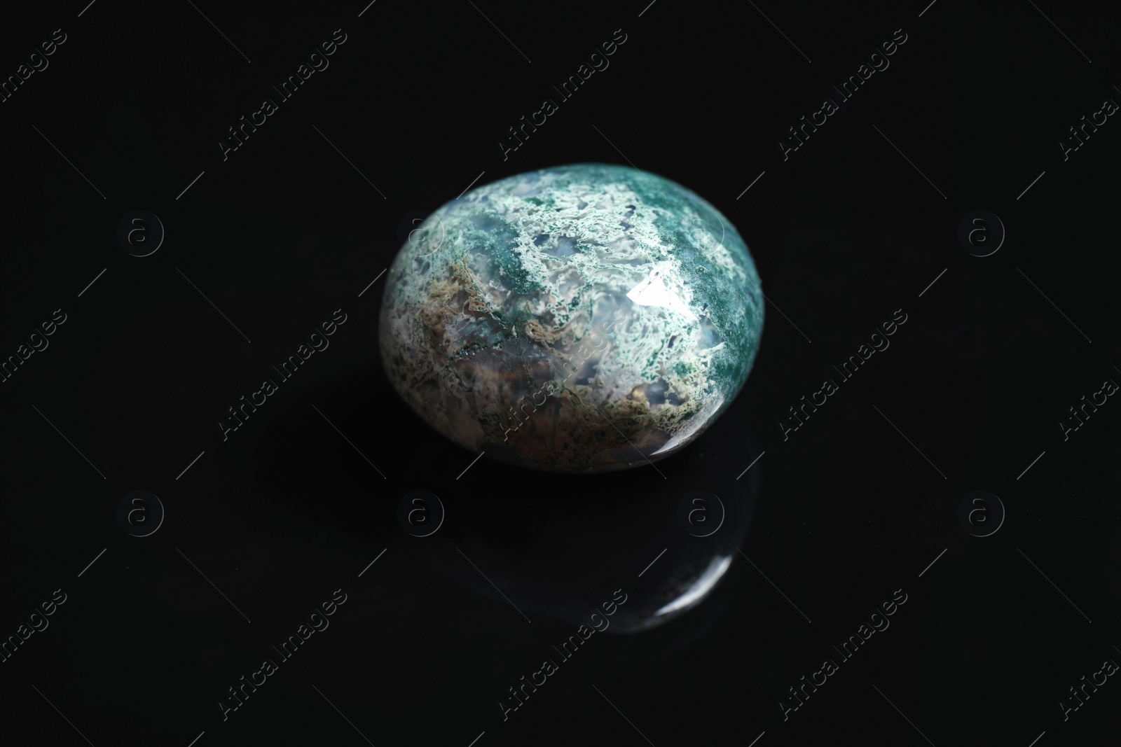 Photo of Beautiful moss agate gemstone on black background