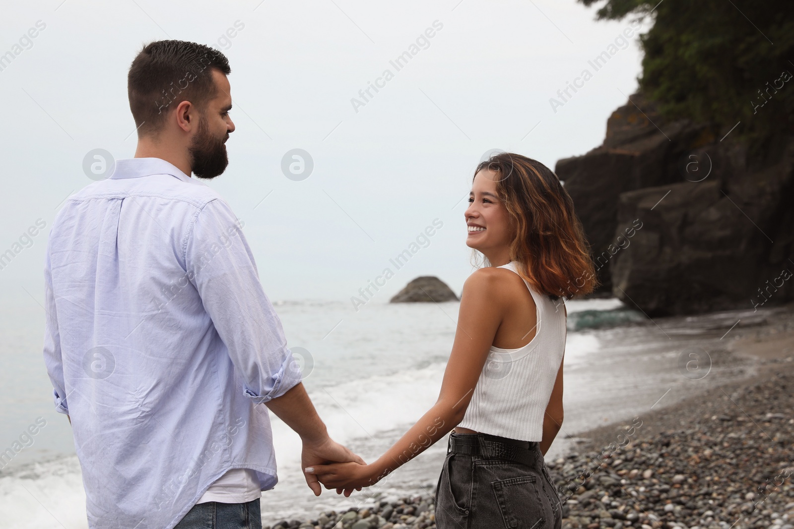 Photo of Happy young couple on beach near sea