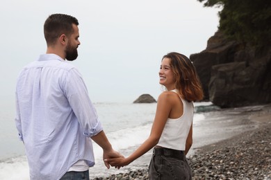 Photo of Happy young couple on beach near sea