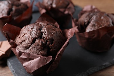 Photo of Tasty chocolate muffins on table, closeup view