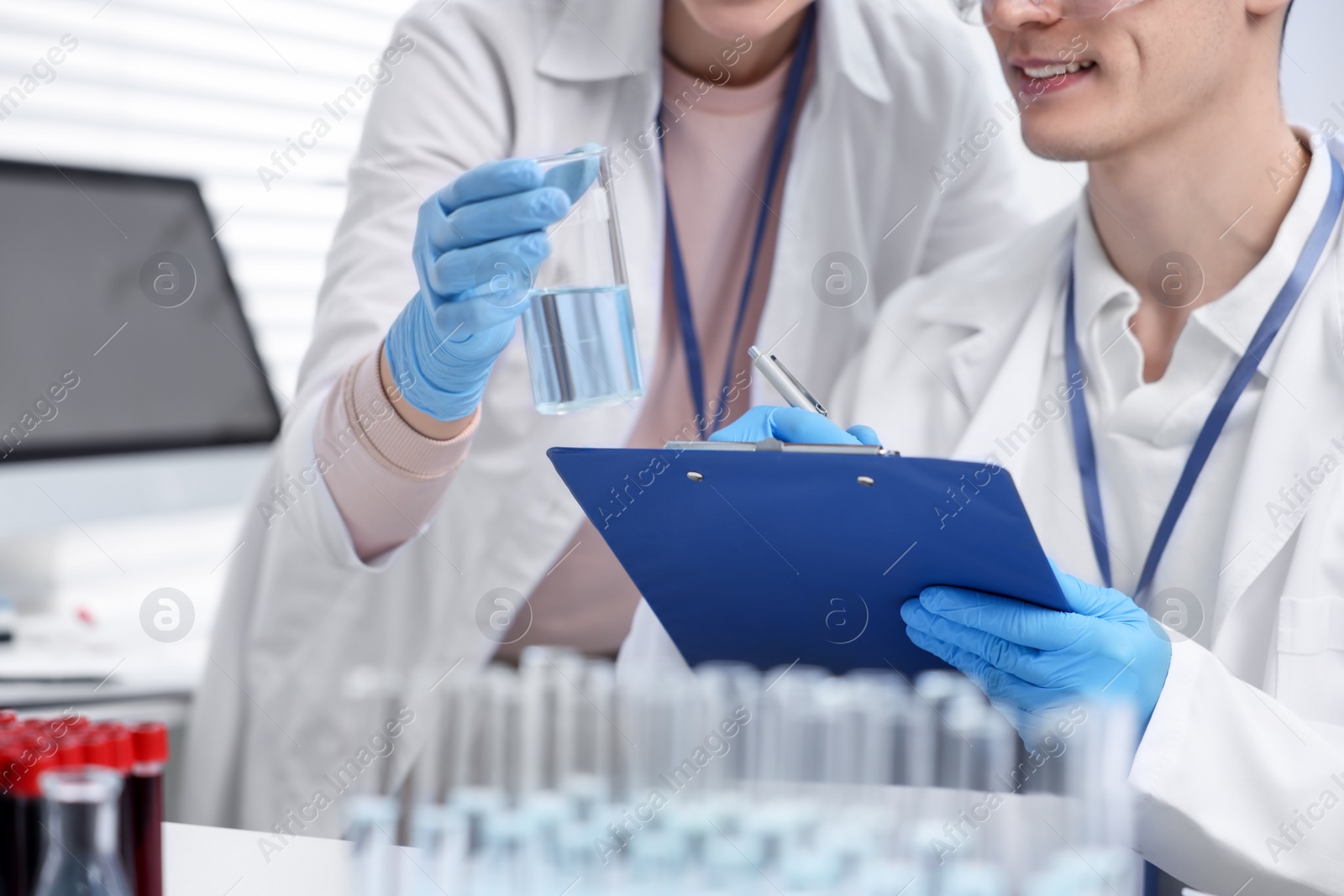 Photo of Scientists working with samples in laboratory, closeup. Medical research