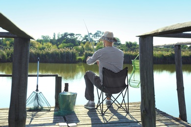 Young man fishing alone on sunny day