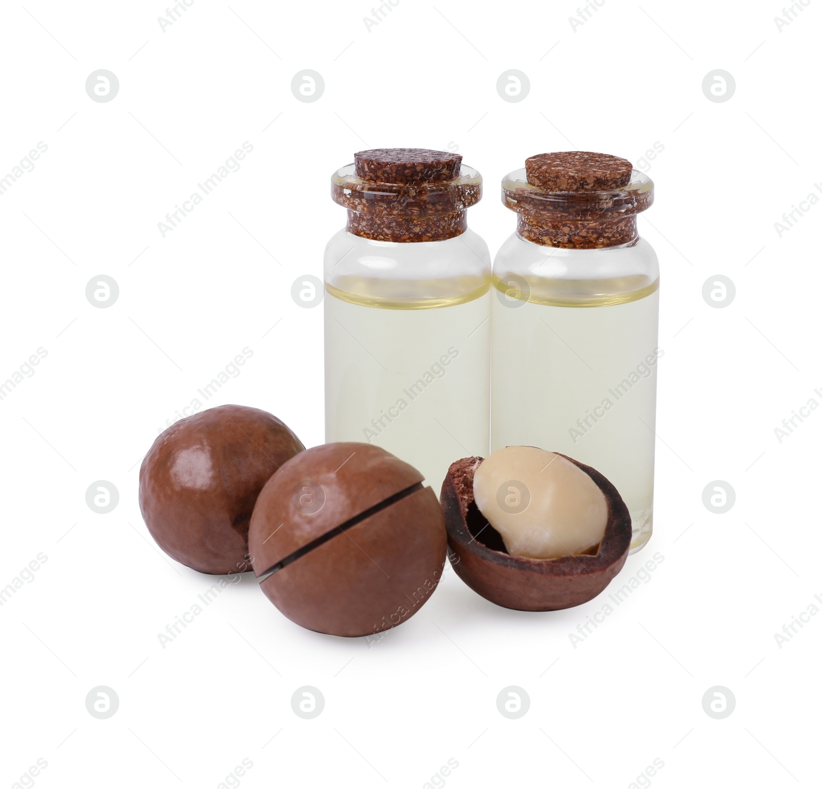 Photo of Delicious organic Macadamia nuts and natural oil isolated on white