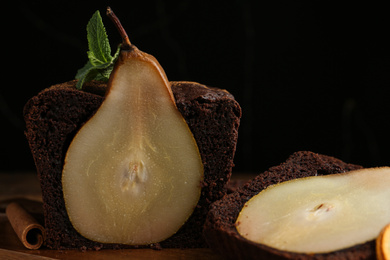 Photo of Tasty pear bread with mint and cinnamon on wooden table, closeup. Homemade cake