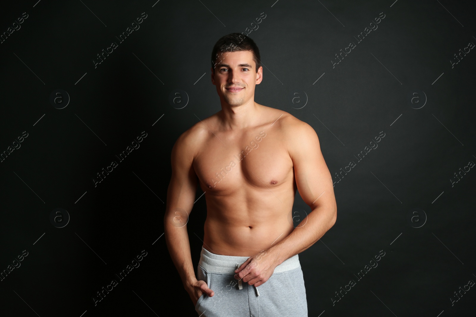 Photo of Man with sexy body on black background