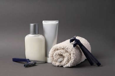 Different men's shaving accessories on dark grey background