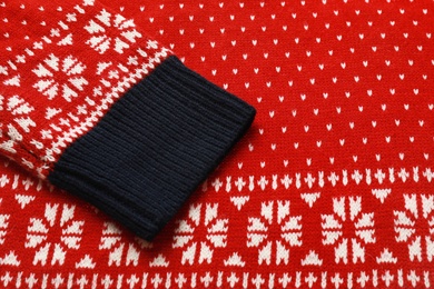 Photo of Warm red Christmas sweater as background, closeup view