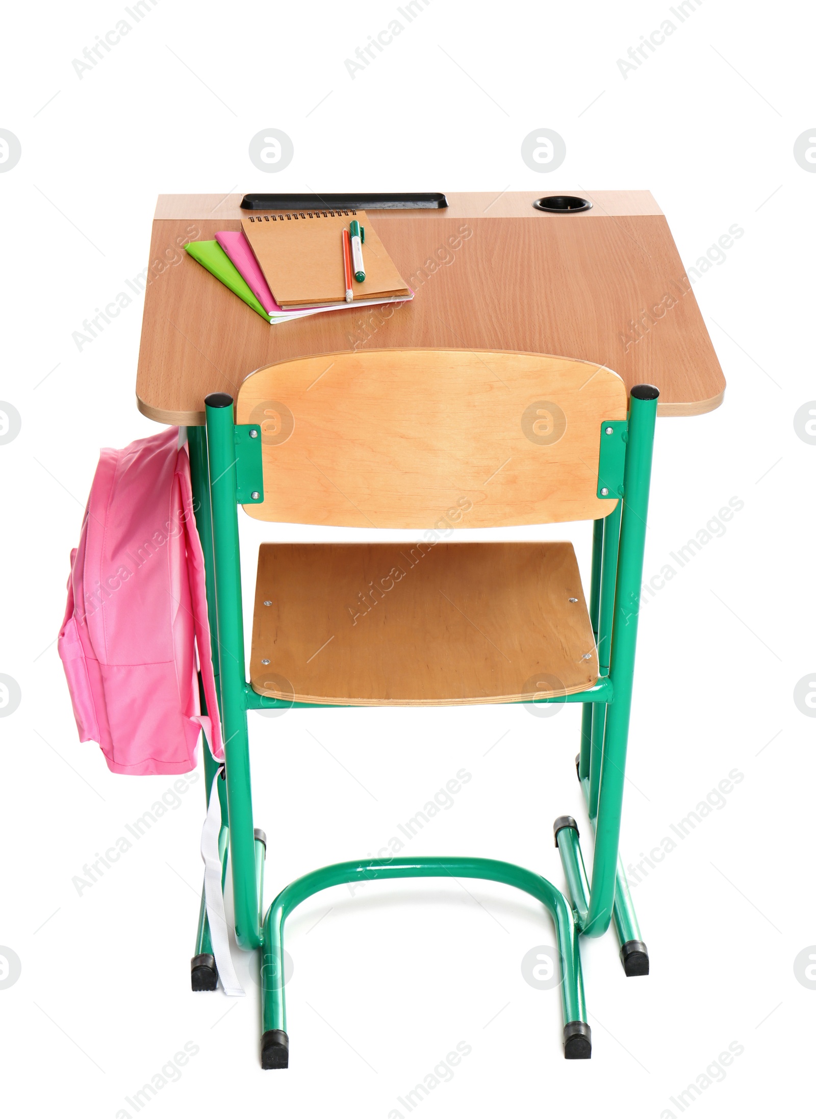 Photo of Wooden school desk with stationery and backpack on white background