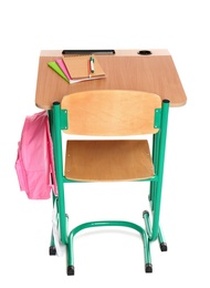 Photo of Wooden school desk with stationery and backpack on white background