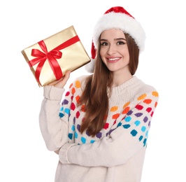 Photo of Happy young woman in Santa hat and sweater with gift box on white background. Christmas celebration