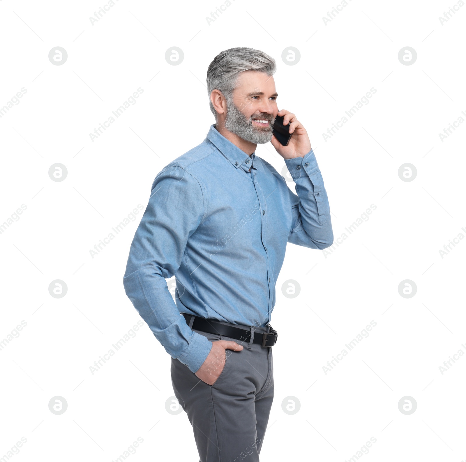 Photo of Mature businessman in stylish clothes talking on smartphone against white background