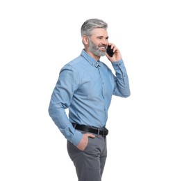 Mature businessman in stylish clothes talking on smartphone against white background