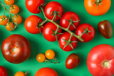 Photo of Flat lay composition with fresh ripe tomatoes on green background