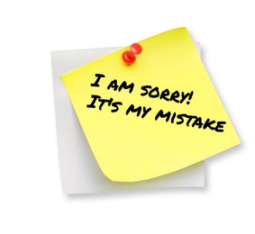 Image of Sticky note with phrase I Am Sorry! It's My Mistake pinned on white background