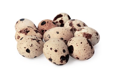 Photo of Many speckled quail eggs on white background