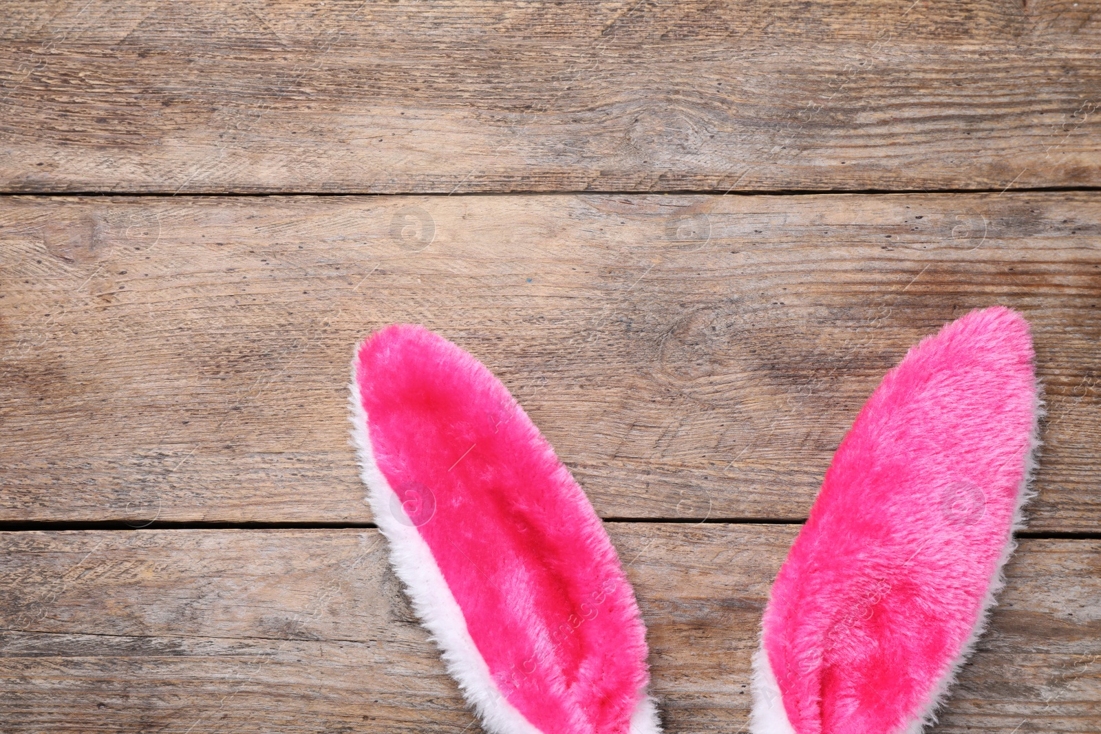 Photo of Decorative bunny ears and space for text on wooden background, flat lay. Easter holiday