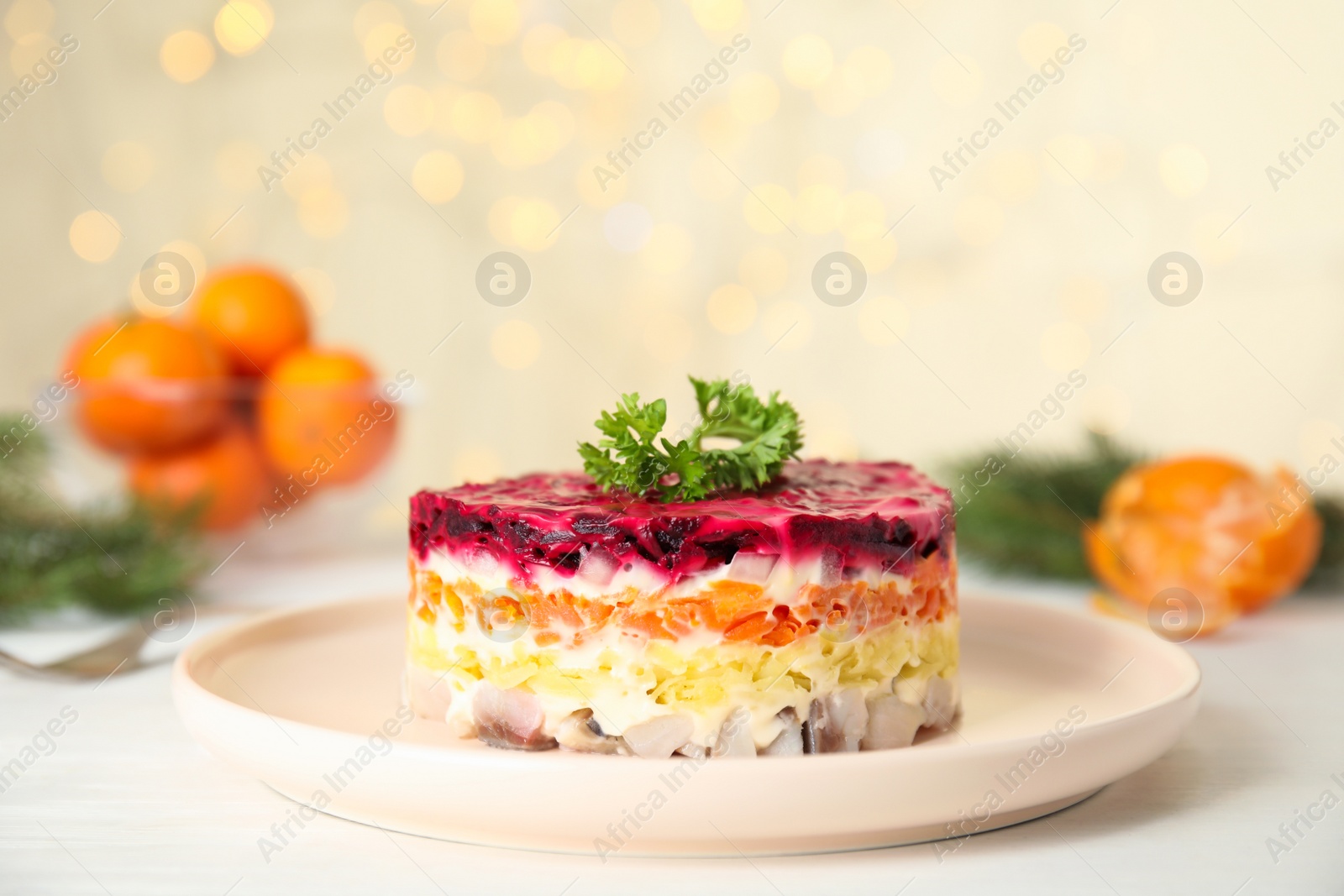 Photo of Herring under fur coat served on white table, space for text. Traditional russian salad