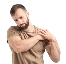 Young man suffering from pain in shoulder on white background