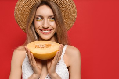 Photo of Young woman with fresh melon on red background, space for text. Exotic fruit