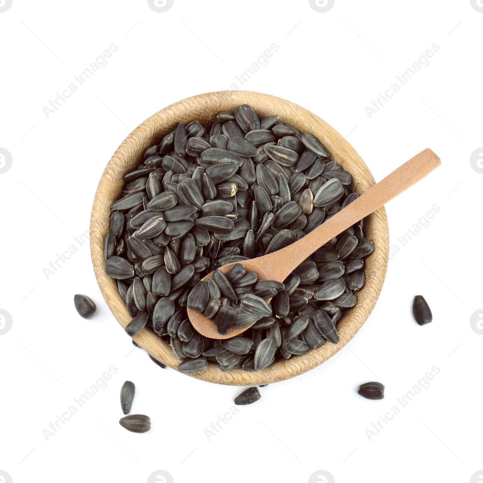 Photo of Sunflower seeds in bowl on white background, top view