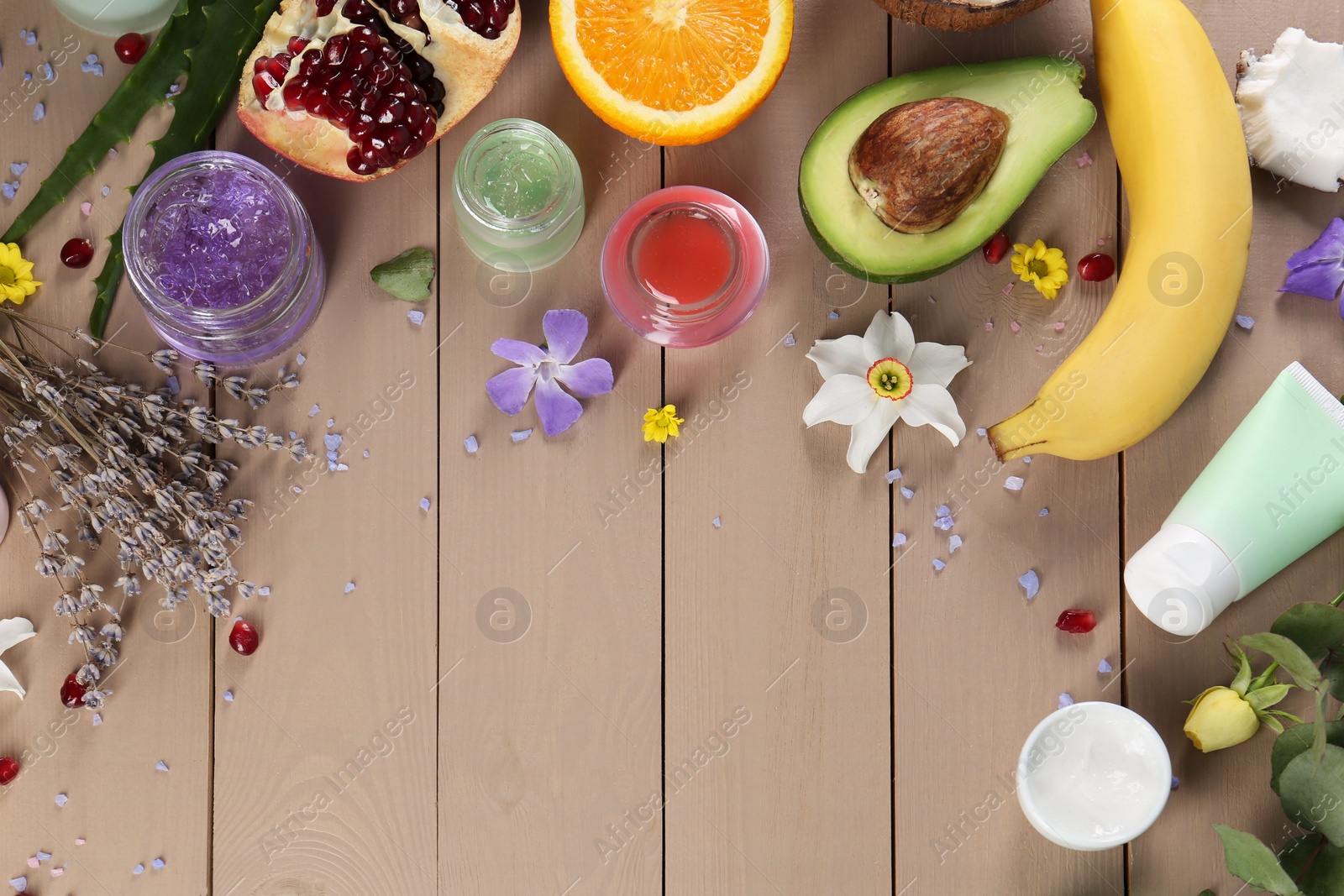 Photo of Flat lay composition with homemade cosmetic products and fresh ingredients on wooden table., space for text. DIY beauty recipe