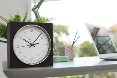 Analog clock on table in office. Time to work