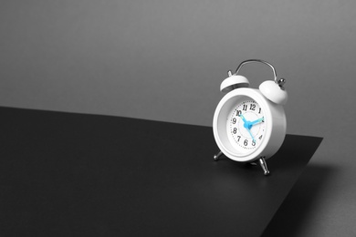 Photo of Alarm clock on dark background. Space for text