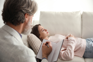 Photo of Psychotherapist and patient in office. Hypnotherapy session