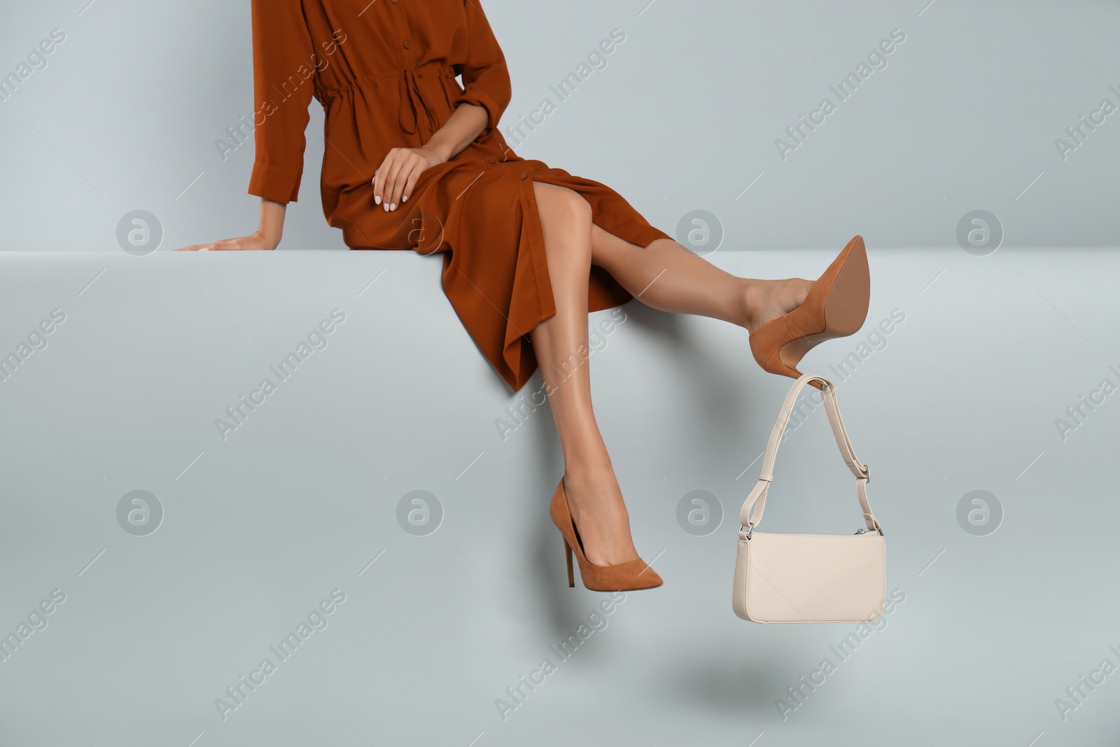 Photo of Woman with stylish bag on grey background, closeup