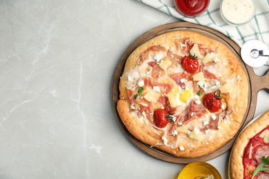 Photo of Delicious homemade pita pizza on light marble table, flat lay. Space for text