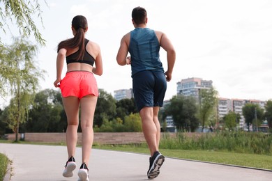 Healthy lifestyle. Couple running outdoors, low angle view