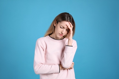 Photo of Portrait of stressed young woman on light blue background