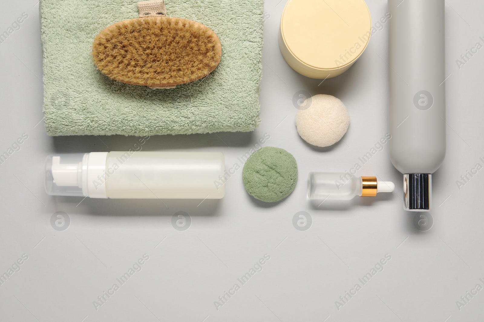 Photo of Bath accessories. Flat lay composition with personal care products on light grey background, space for text