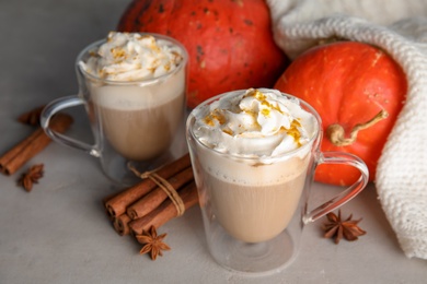 Photo of Composition with tasty pumpkin spice latte on table