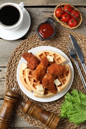 Photo of Delicious Belgium waffles served with fried chicken and butter on wooden table, flat lay