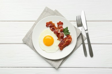 Photo of Delicious breakfast with sunny side up egg served on white wooden table, top view