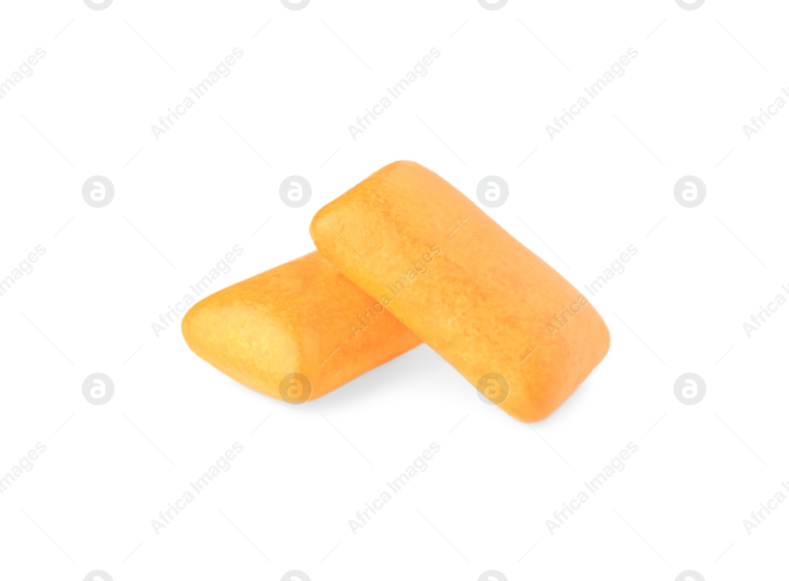 Photo of Tasty orange chewing gums isolated on white
