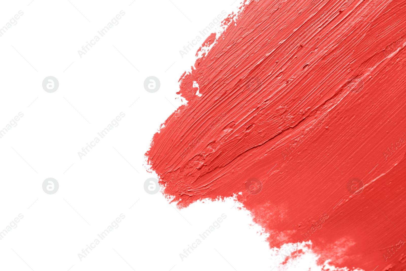 Photo of Red lipstick smears on white background, closeup. Space for text