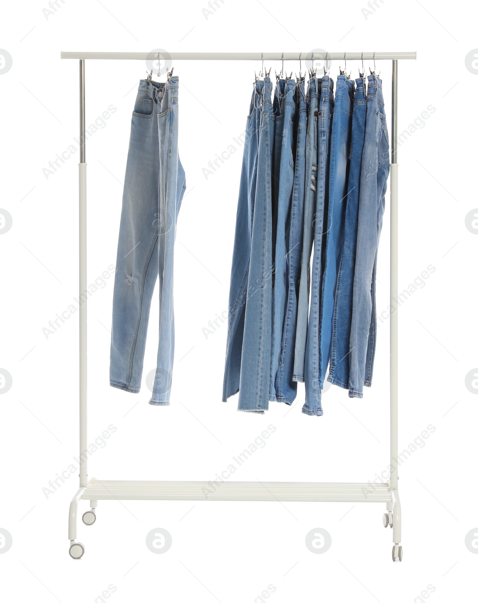 Photo of Rack with different jeans isolated on white