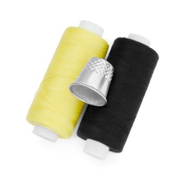 Photo of Thimble and spools of sewing threads isolated on white, top view