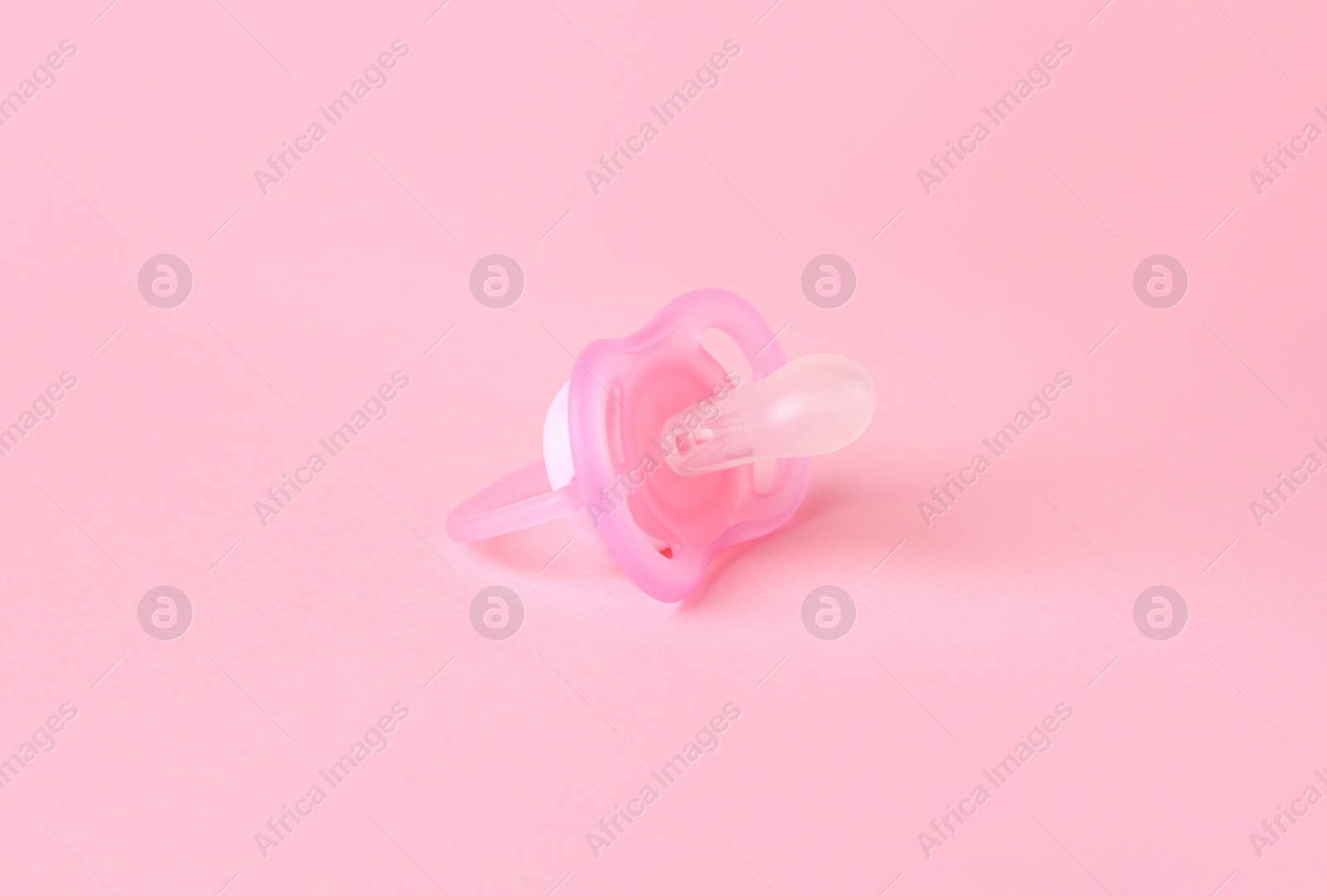 Photo of One new baby pacifier on pink background