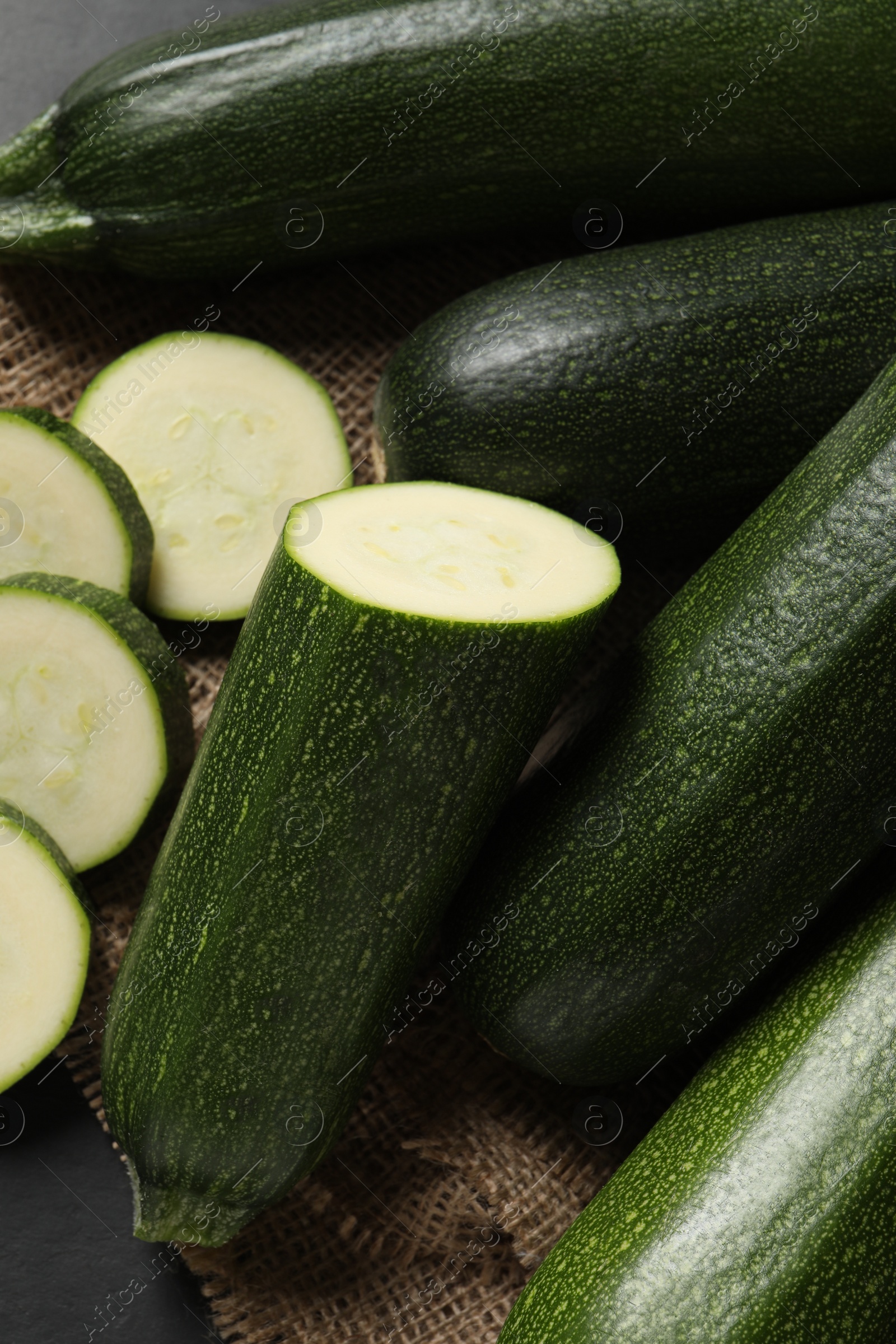 Photo of Whole and cut ripe zucchinis on table, flat lay