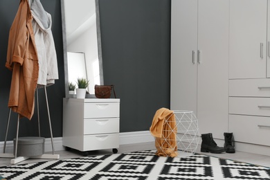 Photo of Stylish hallway interior with large mirror and wardrobe