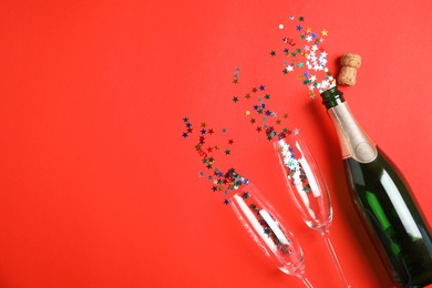 Photo of Creative flat lay composition with bottle of champagne and space for text on color background