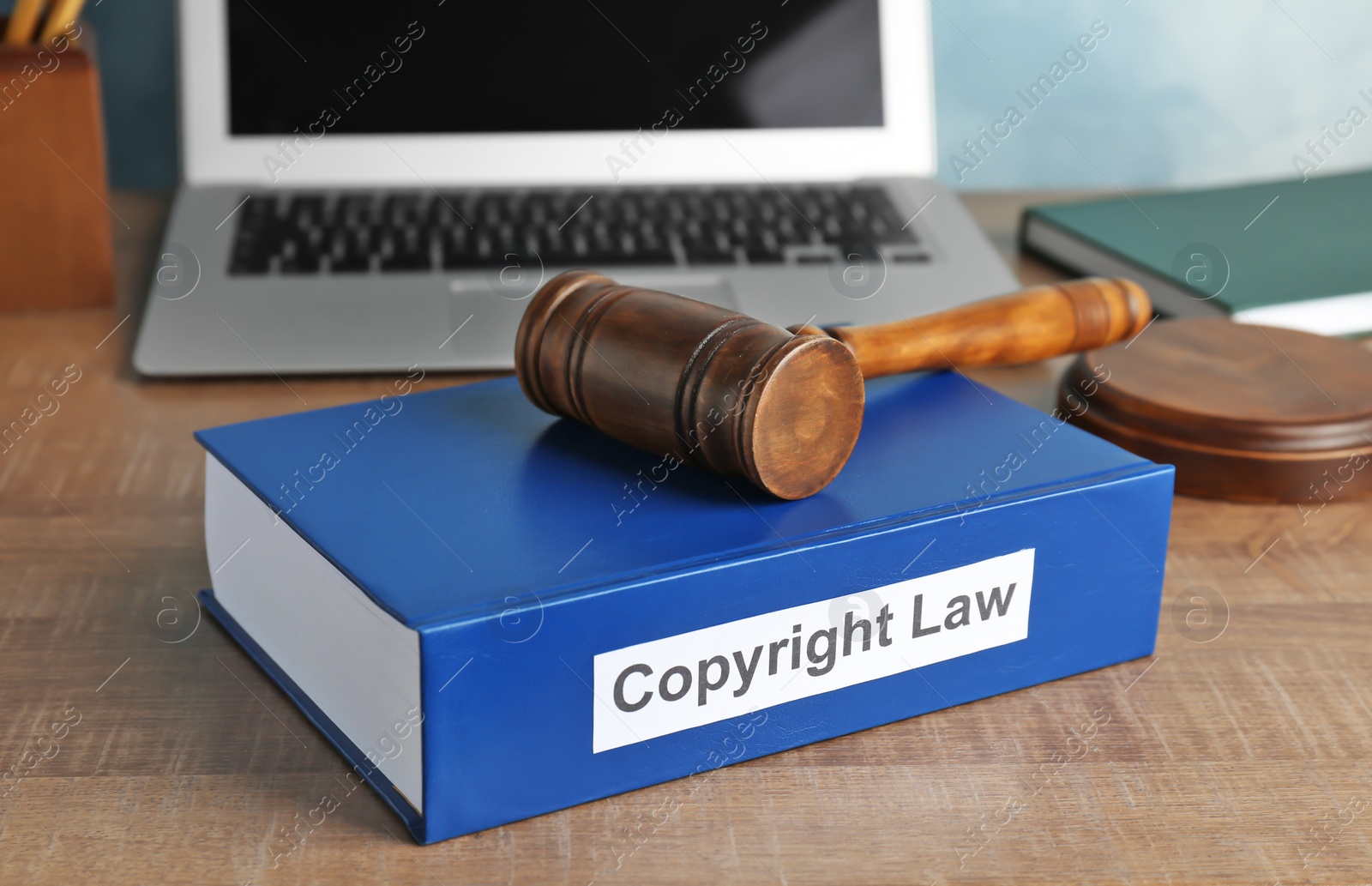 Photo of Book with words COPYRIGHT LAW and gavel on table