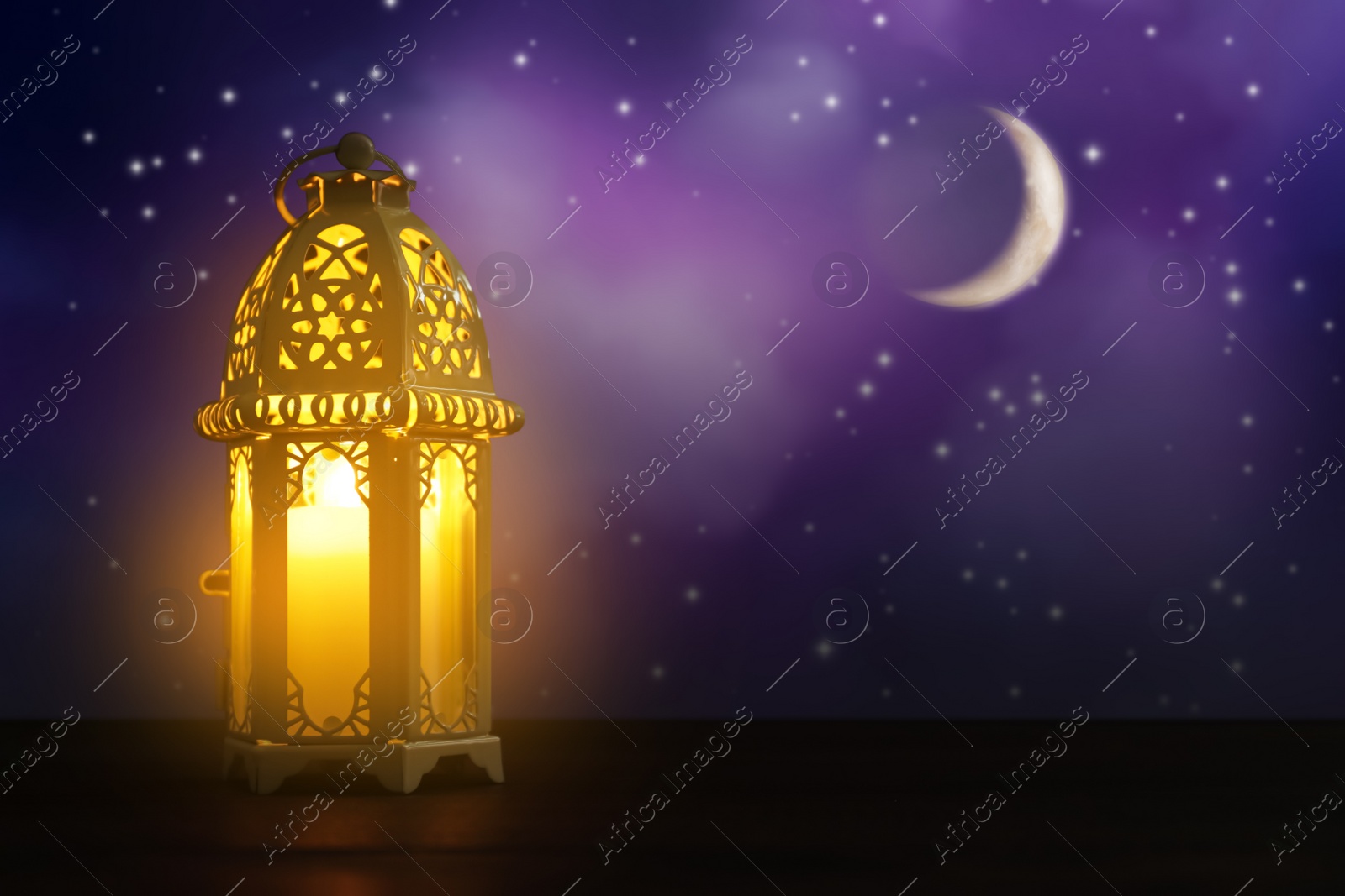 Image of Beautiful decorative Arabic lantern on wooden table at night, space for text. Fanous as Ramadan symbol