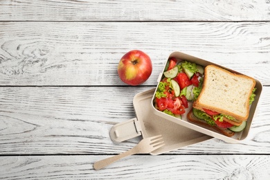 Photo of Flat lay composition with lunch box and appetizing food on wooden background