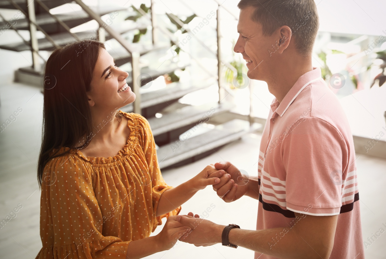 Photo of Man and woman having conversation in hall